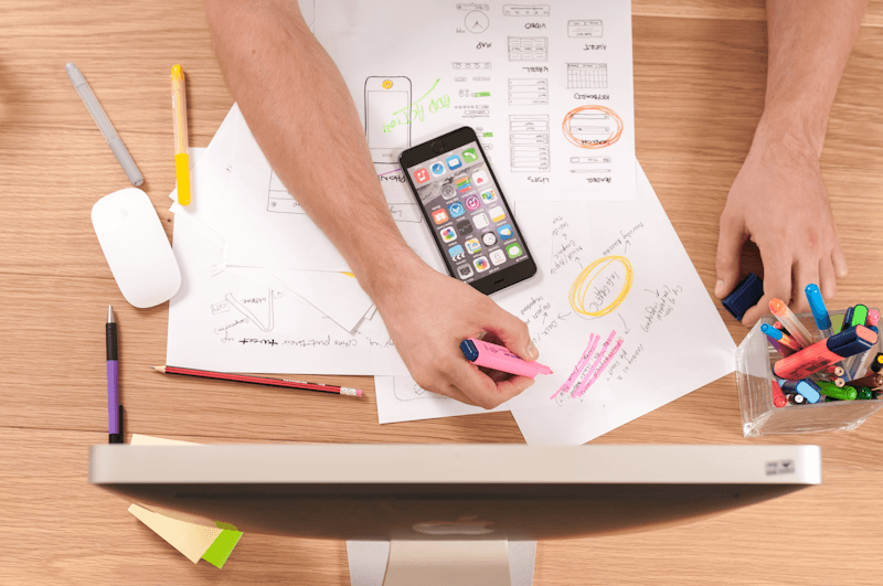 Digital marketing strategist analyzing on-page SEO factors and content hierarchy on a modern workspace desk