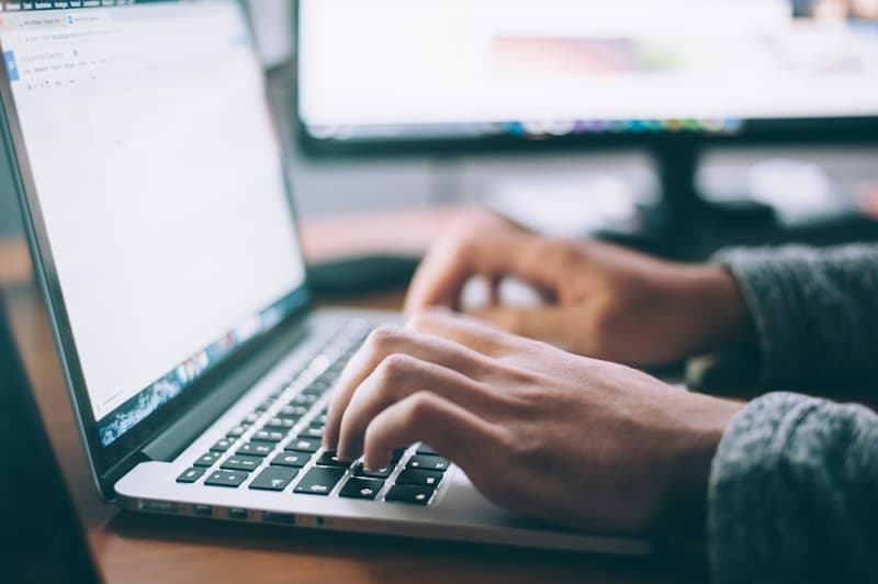 Search engine specialist examining Google Search Console performance curves and keyword impressions report